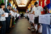Activists and landmine survivors hold placards decrying the US decision to supply anti-personnel landmines to Ukrainian forces