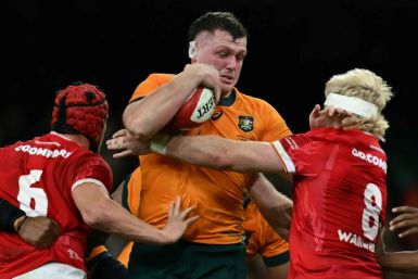 Australia prop Angus Bell is tackled by James Botham and  Aaron Wainwright