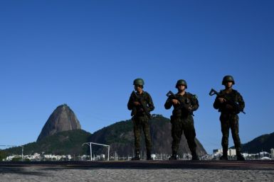 Brazilian army soldiers stand guard on Botafogo beach with the Sugar Loaf mountain in the background during the G20 Summit in Rio de Janeiro