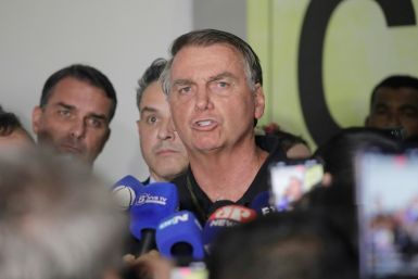 Brazil's former President Jair Bolsonaro speaks with the media upon arrival at the international airport in Brasilia on November 25, 2024