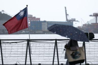 File image of a woman walking past a Taiwanese national flag at Maritime Plaza in Keelung on October 22, 2024