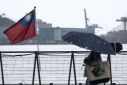 File image of a woman walking past a Taiwanese national flag at Maritime Plaza in Keelung on October 22, 2024