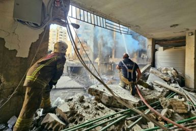 First responders in a building hit by Israel in Beirut's southern suburbs