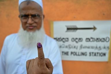 A man shows his inked finger after casting his ballot at a polling station in Sri Lanka on Thursday
