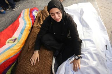A Palestinian girl mourns over the bodies of victims of an Israeli strike south of Gaza City