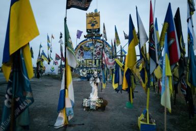 A religious statue stands amid banners of Ukrainian military units at the border with Donetsk