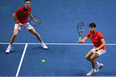 Spain's Carlos Alcaraz and Spain's Marcel Granollers return a ball  in the doubles match