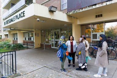 Sultana Jahangir, the executive director of the South Asian Women and Immigrants' Services talks with clients outside the organization's office in Toronto