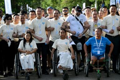 Survivors and sniffing dogs joined hundreds of people at Cambodia's Angkor Wat for a march against landmines