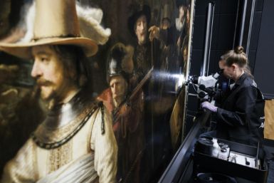 Technicians are working to remove layers of varnish from Rembrandt's "The Night Watch" to restore the Dutch Golden Age masterpiece