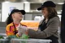 US Vice President Kamala Harris speaks with her great-niece Leela Ajagu as they help prepare Thanksgiving dinner at DC Central Kitchen in Washington, DC